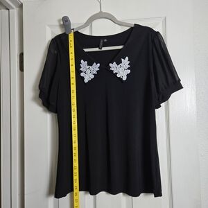 Elegant Black Top with White Floral Accents